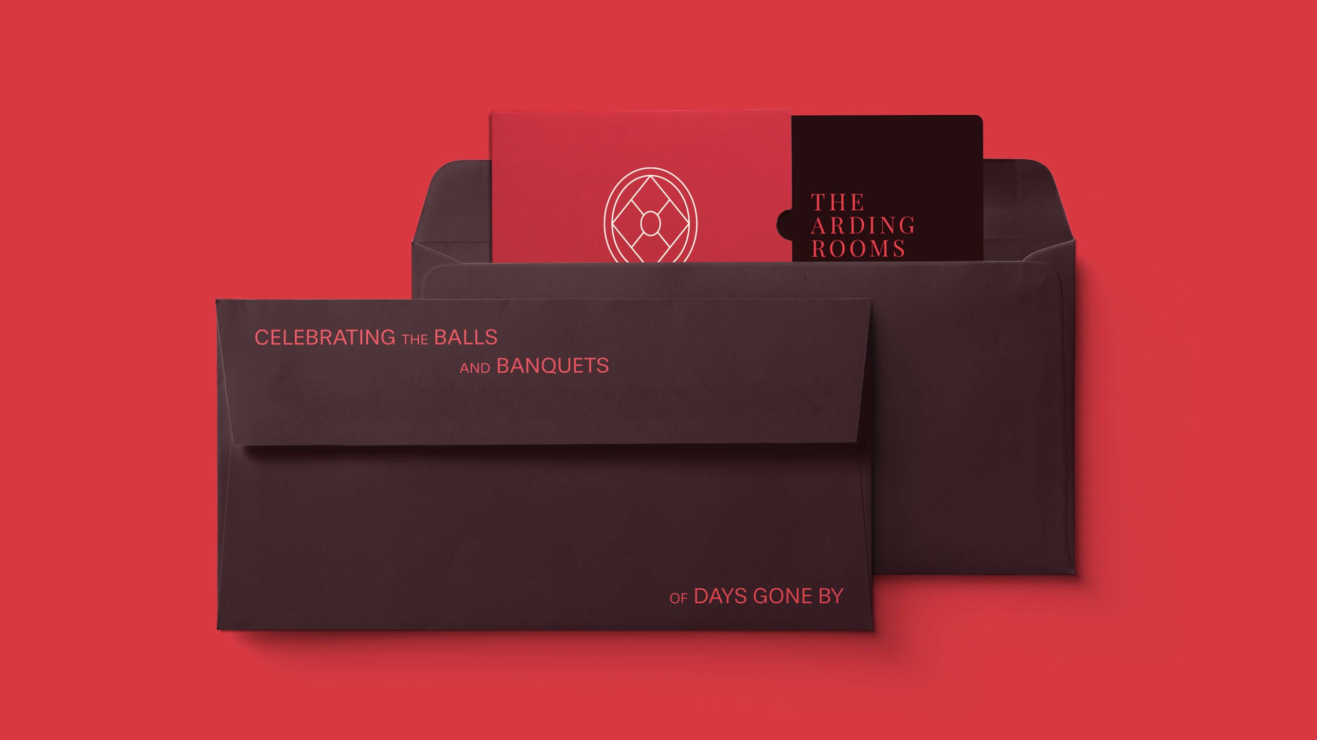 Dark red and black stationery set for The Arding Rooms featuring envelopes and invitations