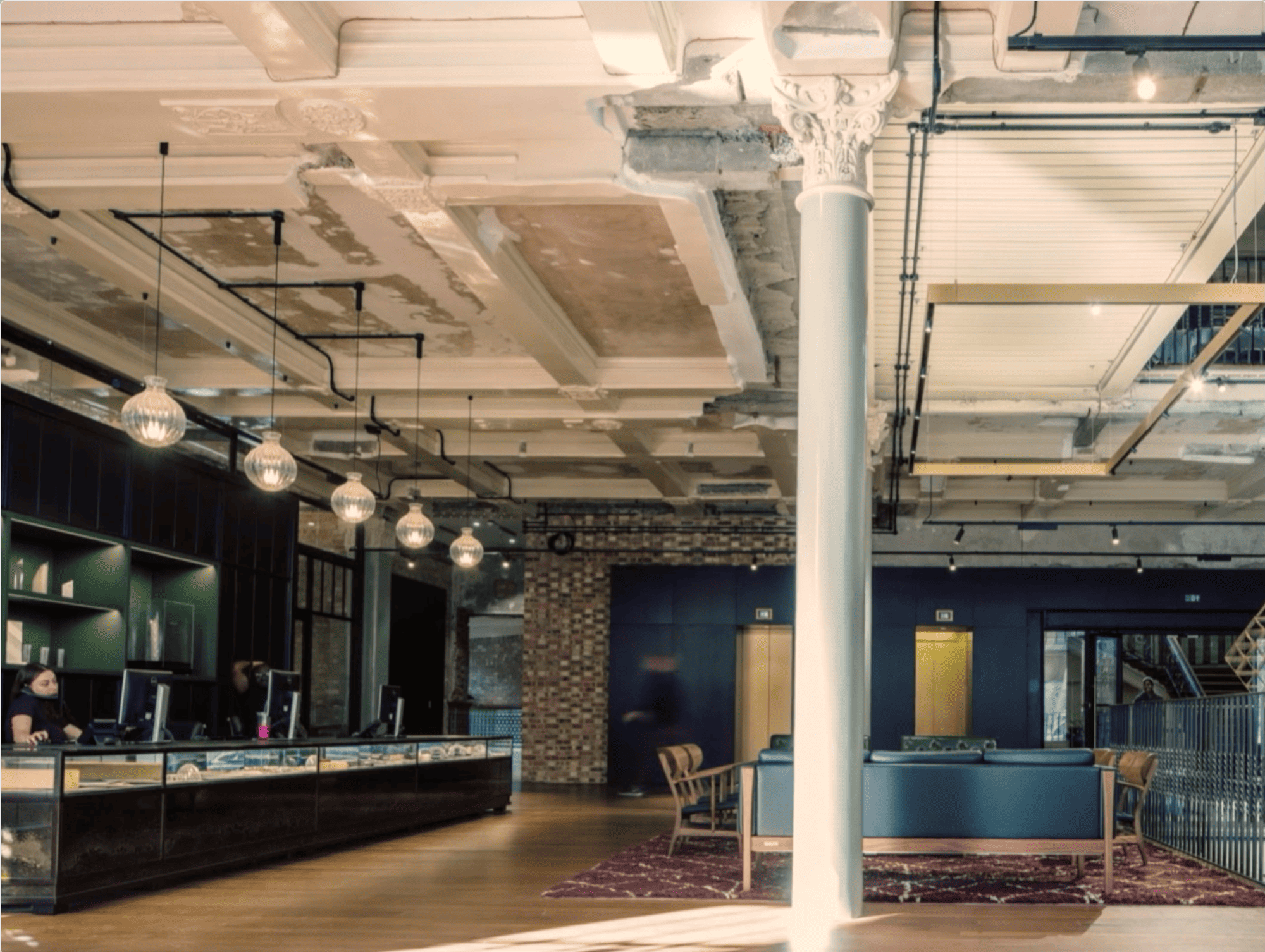 Reception and lobby space inside The Department Store with exposed ceilings and modern industrial décor