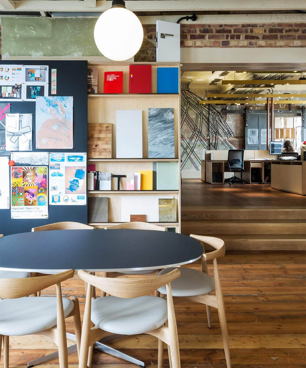 Creative studio workspace inside The Department Store Brixton with exposed brick and eclectic materials library.