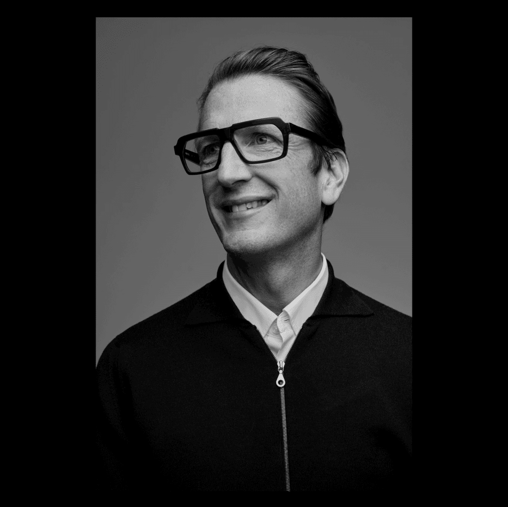 Black-and-white studio portrait of a woman facing the camera with a calm expression